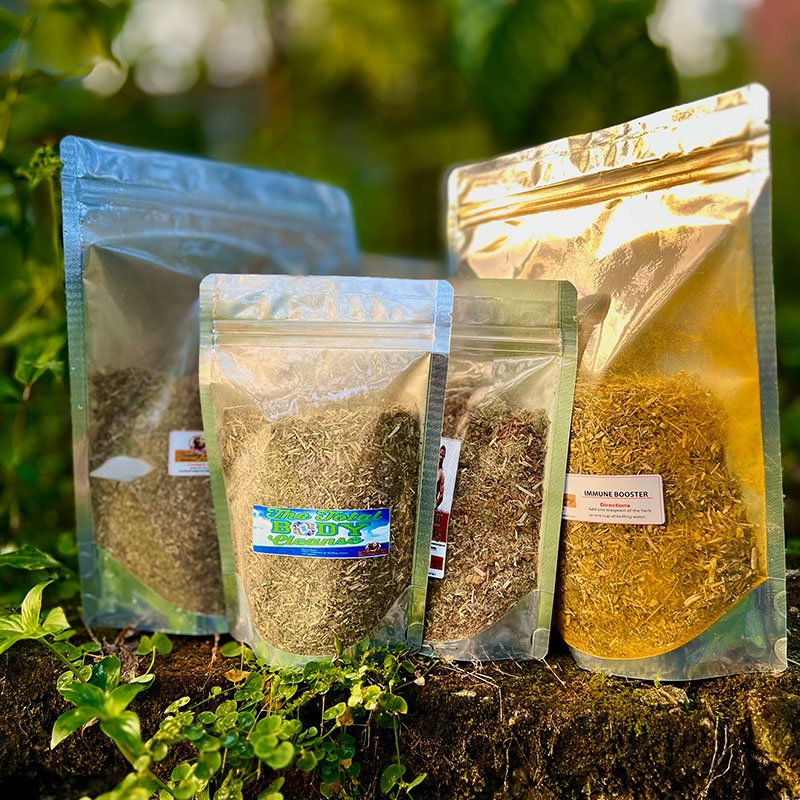 Four resealable bags of various grains displayed outdoors on greenery.