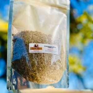 A clear bag of organic golden quinoa against a blue sky.