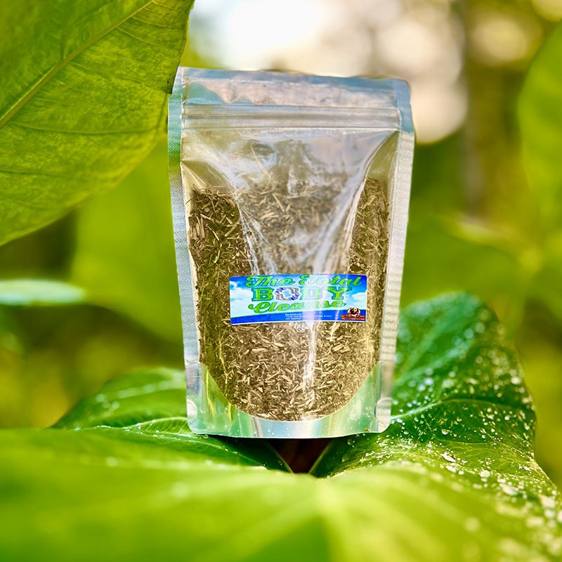 A resealable bag of dried herbs on a large green leaf outdoors.