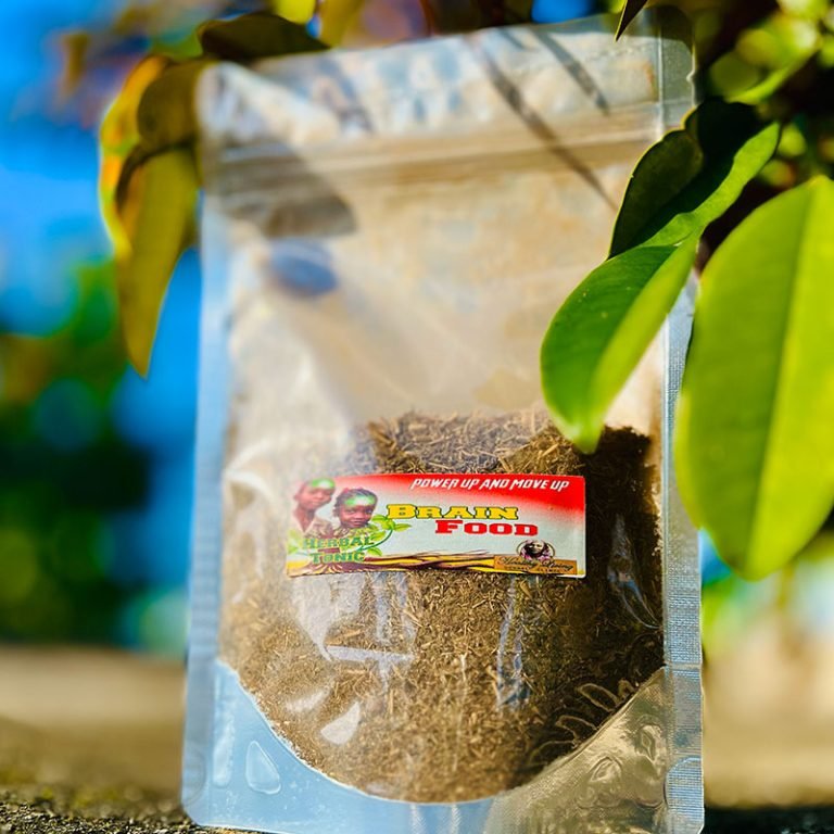 Packaged herbal powder with green leaves in sunlight.