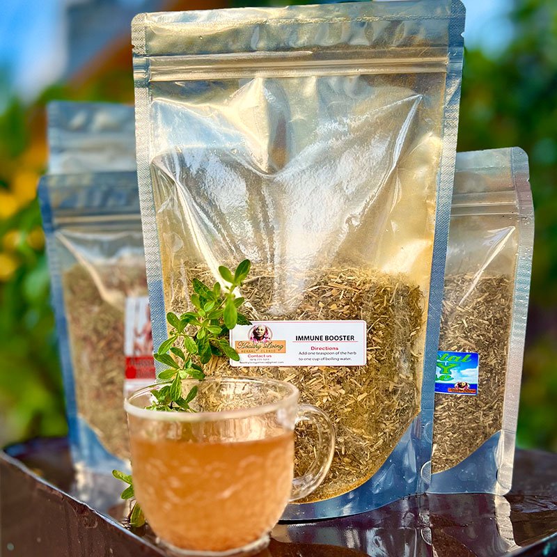 Three packages of herbal tea with a cup of brewed tea in front.