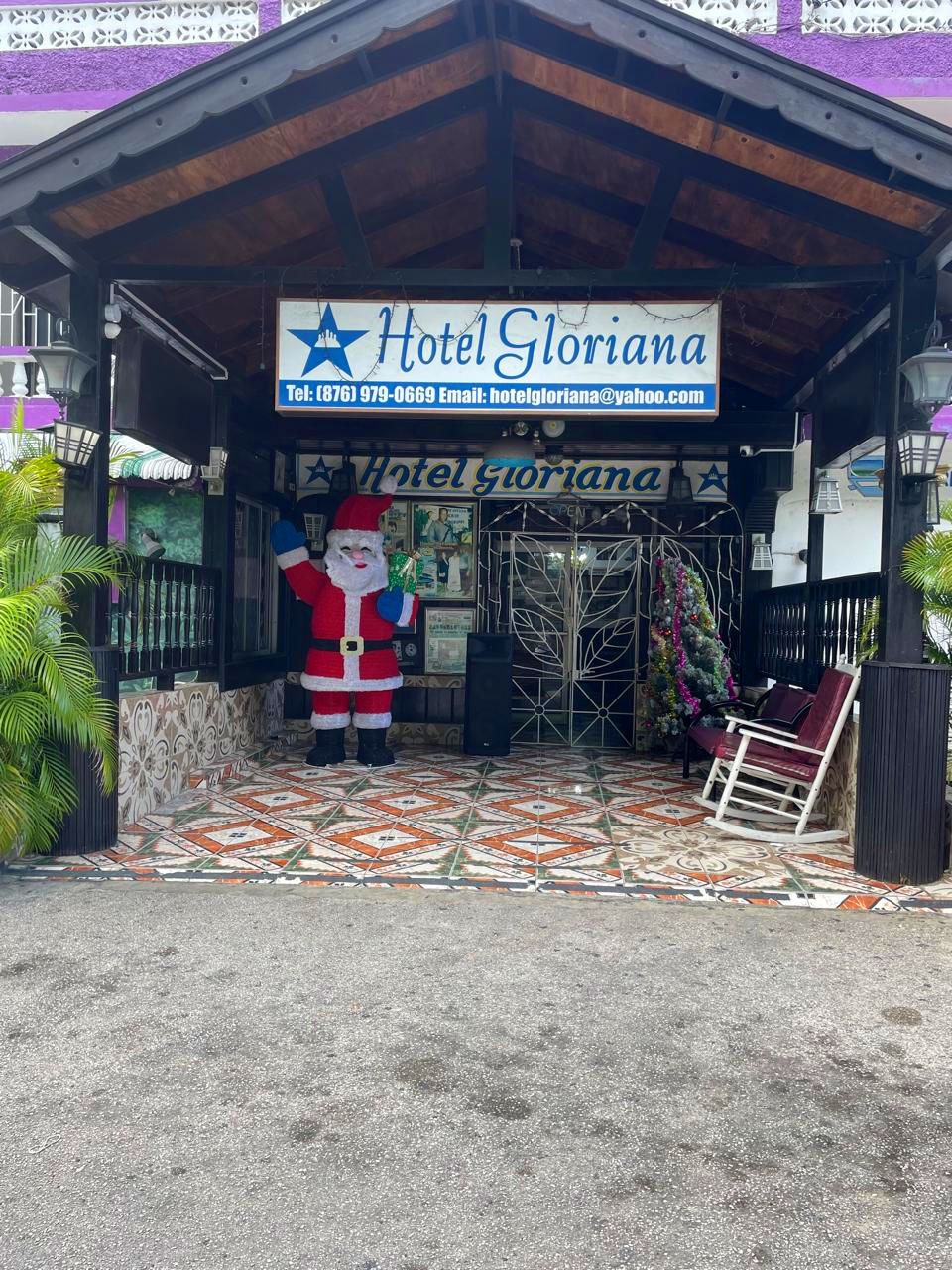 Entrance of Hotel Gloriana with festive Santa Claus decoration.