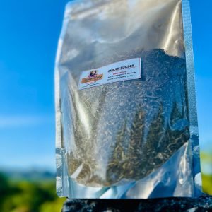 Silver pouch of dried oregano against a clear blue sky.