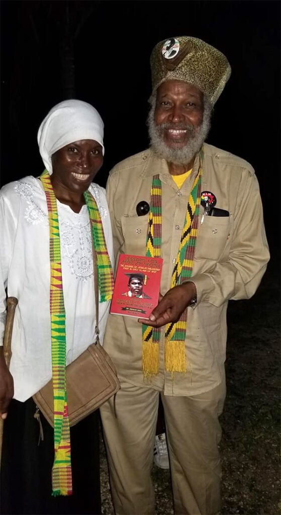 Smiling young woman with acne, wearing a white t-shirt.