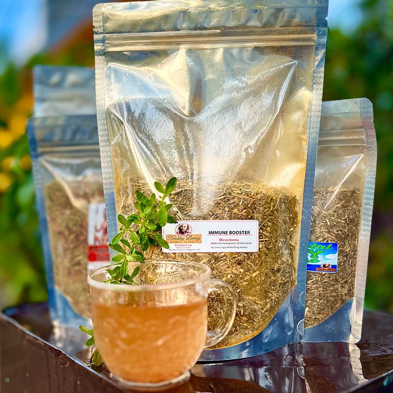 Three bags of green tea leaves with a glass cup of brewed tea.