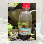 A plastic bottle labeled "Priority Case" placed on rocks outdoors.